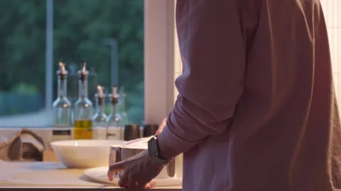 Spreading cream on cake layer with spatula, as woman takes filling from plate Video stock 342654530