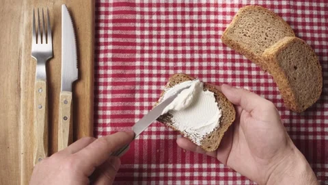 Spreading cream cheese on slice of bread. Bread and cheese toast Video stock 181004603