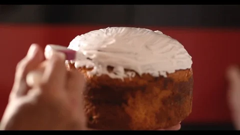 Spreading cream on Easter bread Stock Footage 128545420