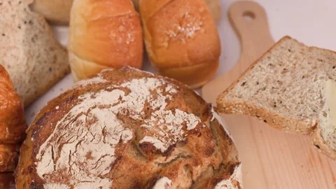 Spreading Creamy Butter on Multigrain Bread Slice Video stock 337767535