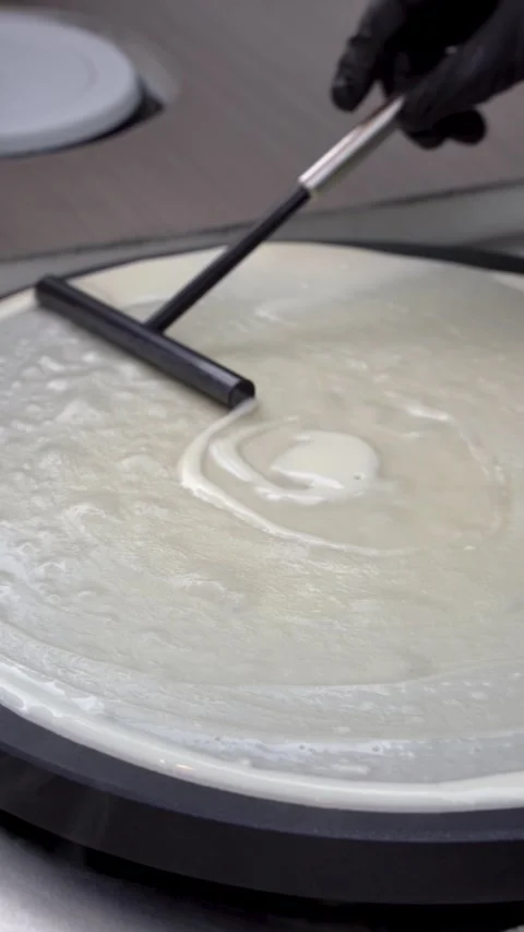 Spreading Crepe Batter on a Griddle Stock-Footage 336853297