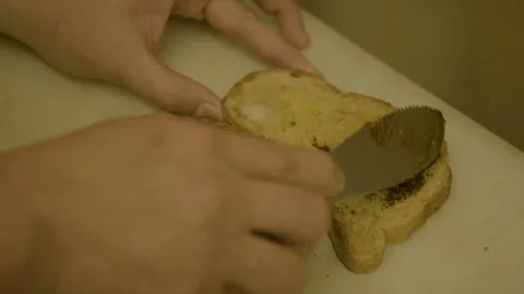 Spreading Dark Spread on Toasted Bread Slices in Sydney Cafe Kitchen, Australia Stock Footage 345654323