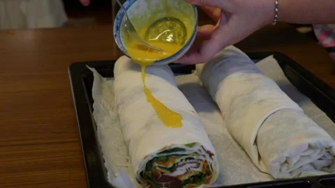 Spreading Egg Yolk on Raw Pastry Dough Before Baking Stock Footage 330826408
