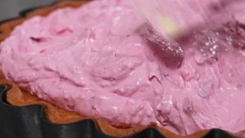 Spreading Fresh Pink Raspberry Mousse Filling into a Fluted Pastry Tart Shell 库存影片 337751225