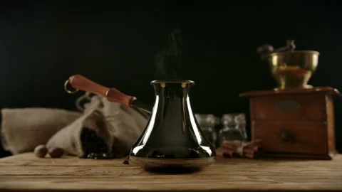 Spreading freshly ground coffee spoons into cezve by neat female hand Stock Footage 135809446
