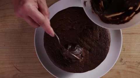 Spreading ganache onto a chocolate cake Stock Footage 64055672