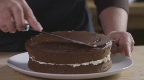 Spreading ganache over a chocolate cake Stock Footage 64055343