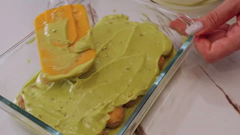 Spreading Green Cream Smoothly Over Savoiardi Biscuits With Spatula In Glass Dis Stock Footage 326638760