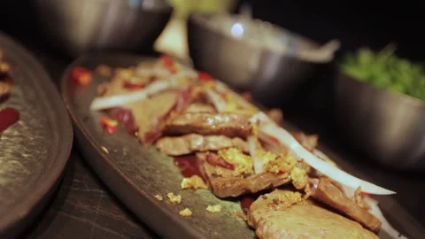  spreading herbs on slices of roast meat Stock Footage 300028229