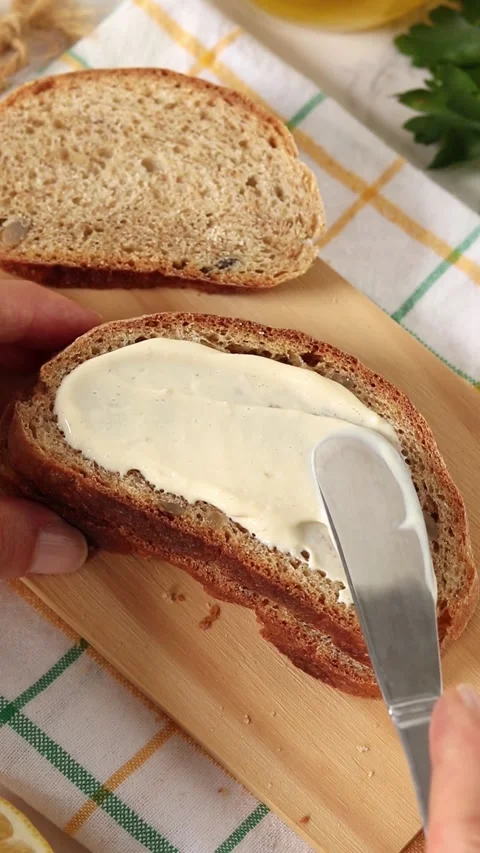 Spreading homemade mayonnaise on a bread slice Stock Footage 337418218