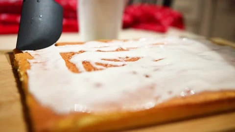 Spreading icing on top of a cake Stock Footage 228434134