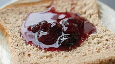 Spreading jam on on slice bread. 스톡 동영상 238780145