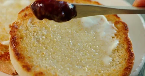 Spreading jam on toast with butter Stock Footage 99735190