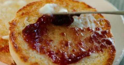 Spreading jam on toast with butter Stock Footage 99735317