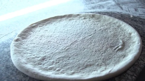 Spreading ketchup on a Pizza Dough 動画素材 77559624