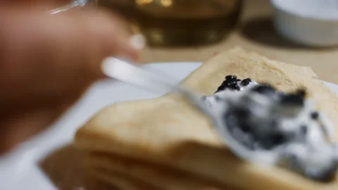 Spreading lump fish black roe with taramasalata on blinis. Isolated closeup Stock Footage 144885332