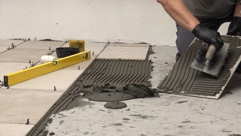 Spreading mortar on the back of a tile Stock Footage 111866765