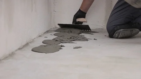 Spreading mortar on the floor Stock Footage 111866323
