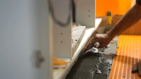 Spreading Mortar Mix to Bind Ceramic Tiles &amp; Membrane on The Floor Stock Footage 95488311