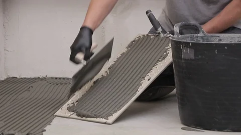 Spreading mortar on a tile Stock Footage 111866307