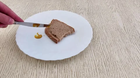 Spreading Mustard on Whole Wheat Bread for a Simple Sandwich Stock Footage 320600537