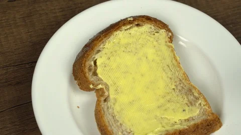 Spreading organic orange jam on batter bread Stock Footage 113074854