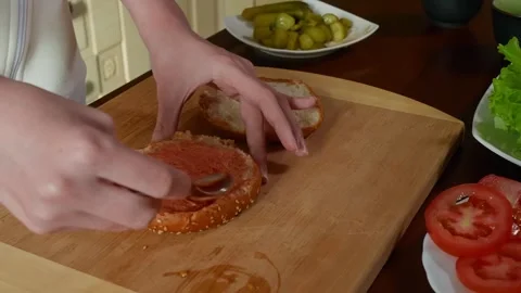 Spreading pate on seeded bread during food preparation, overhead kitchen view Stock Footage 345060739