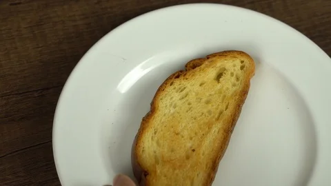 Spreading peanut butter on baked bread Video stock 113074175
