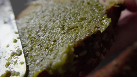 Spreading Pesto on Multigrain Bread Stock Footage 285566469