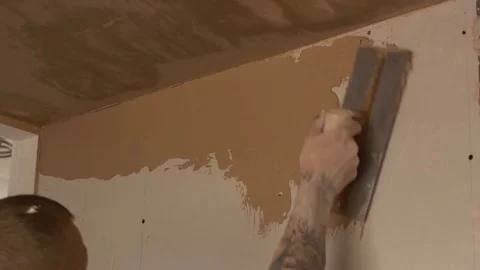 Spreading plaster skim on to plaster boards Stock Footage 82009222