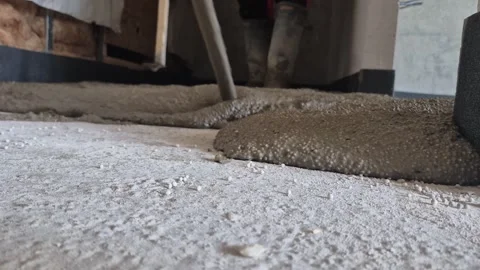 Spreading polystyrene concrete in hallway low angle slow motion Stock Footage 341510069