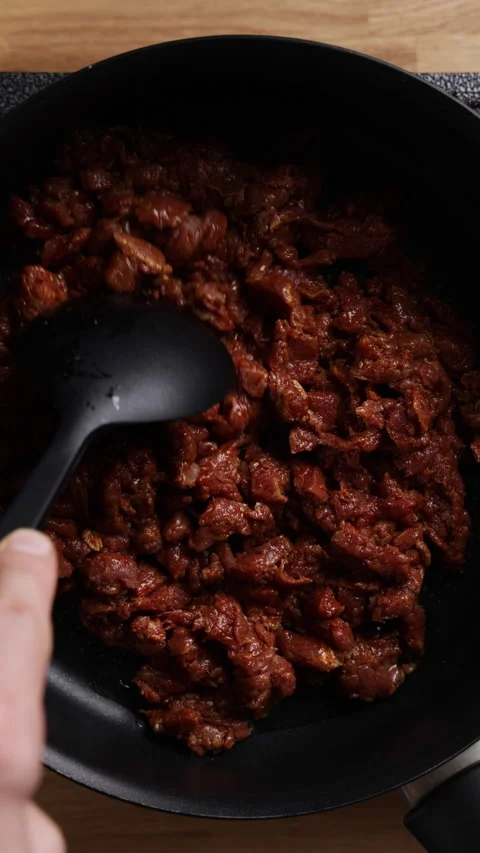 Spreading Raw Meat In Frying Pan With Spoon Top View Видео 330573657