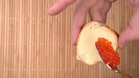 Spreading red caviar on bread and butter. cooking apitizers Stock Footage 122254458