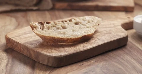 Spreading ricotta cheese on fresh rustic bread Stock Footage 74519198