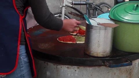 Spreading Salsa on Tortilla Shell on Outdoor Skillet 스톡 동영상 50249581