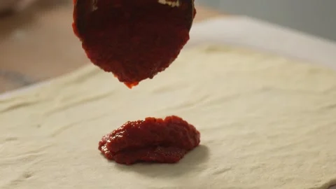 Spreading sauce on pizza dough. Stock Footage 266014912