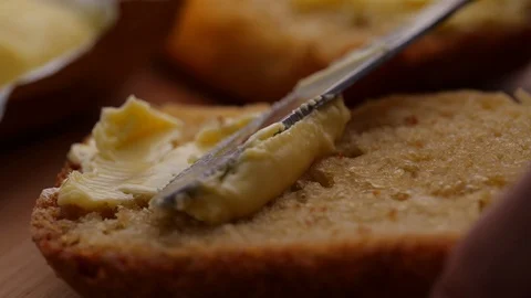 Spreading soft butter on homemade bread. Shot in 4k Slow motion Video stock 129068979