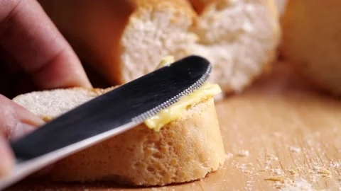 Spreading soft butter on homemade bread in 4k slow motion Stock Footage 130839696