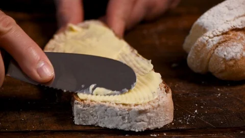 Spreading soft yellow butter on bread Video stock 123150876