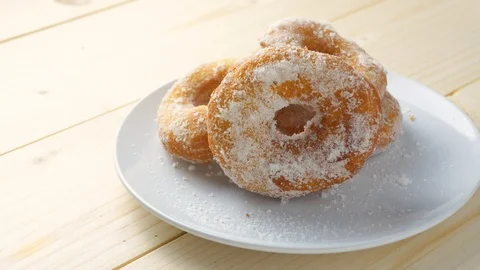 Spreading sugar on doughnuts for breakfast Stock Footage 127167366