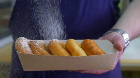Spreading sugar powder on donuts. Stock Footage 154270936