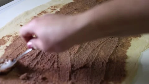 Spreading sweet chocolate filling on the risen dough. Stock Footage 298334301