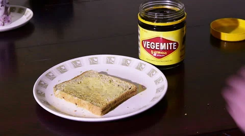 Spreading Vegemite on toast Stock Footage 53770078