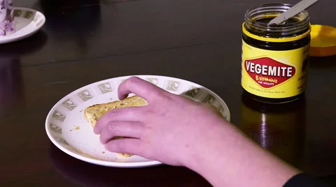 Spreading Vegemite on toast Stock Footage 53770262