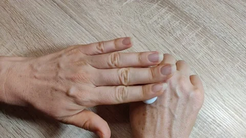 Spreading white cream on hands Stock Footage 156663418