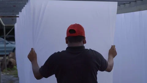 Spreading white material sheet of fabric cloth outside Stock Footage 108798858