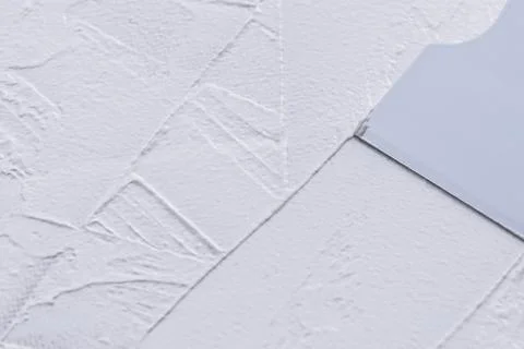 Spreading white putty with plastic spatula, close up Stock-Fotos