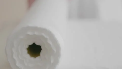 Spreading white roll disposable sheet on massage table preparing on procedure. Stock Footage 197657894