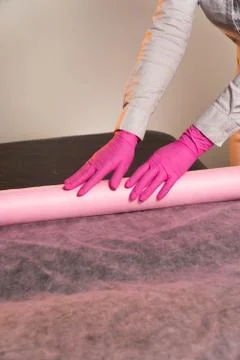 Spreads a sheet on a massage couch Stock Photos