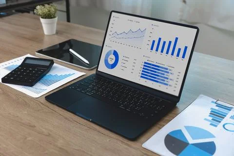 Spreadsheet data and business dashboard displayed on a laptop with charts, .. Stock Photos